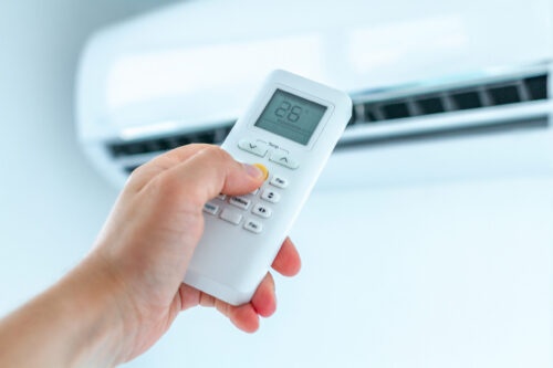 person holding AC remote